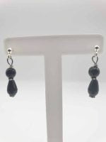 Pair of BLACK ONYX EARRINGS SMALL DROP on easel.