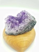 An 8 CM DRAETHYST FOR PURIFICATION sits on top of a wooden heart for purification.