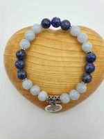 A SILVER AQUAMARINE AND LAPIS LAZULI BRACELET with owl charm.