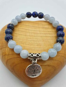 A SILVER AQUAMARINE AND LAPIS LAZULI BRACELET featuring a tree of life pendant and blue lapis lazuli, accented with aquamarine.