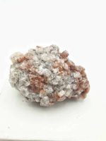 A piece of rock adorned with delicate brown and white crystalline ARAGONITE ROSETTES.