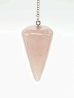A PENDULUM ROSE QUARTZ RADIESTHESIA DIVINATION hanging from a chain.