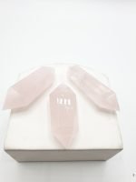 Two-ended rose quartz tips in white box.