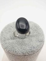 AN OVAL BLACK ONYX RING with black oval stone.