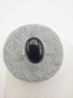 AN OVAL BLACK ONYX RING on a white background.