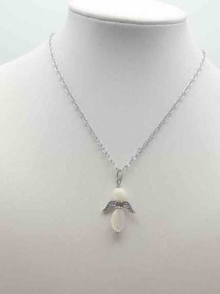A MOTHER-OF-PEARL ANGEL PENDANT depicting a white angel on a silver chain.