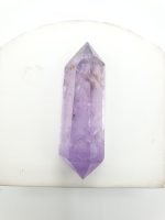 Purple amethyst biterminated tips on a white table.