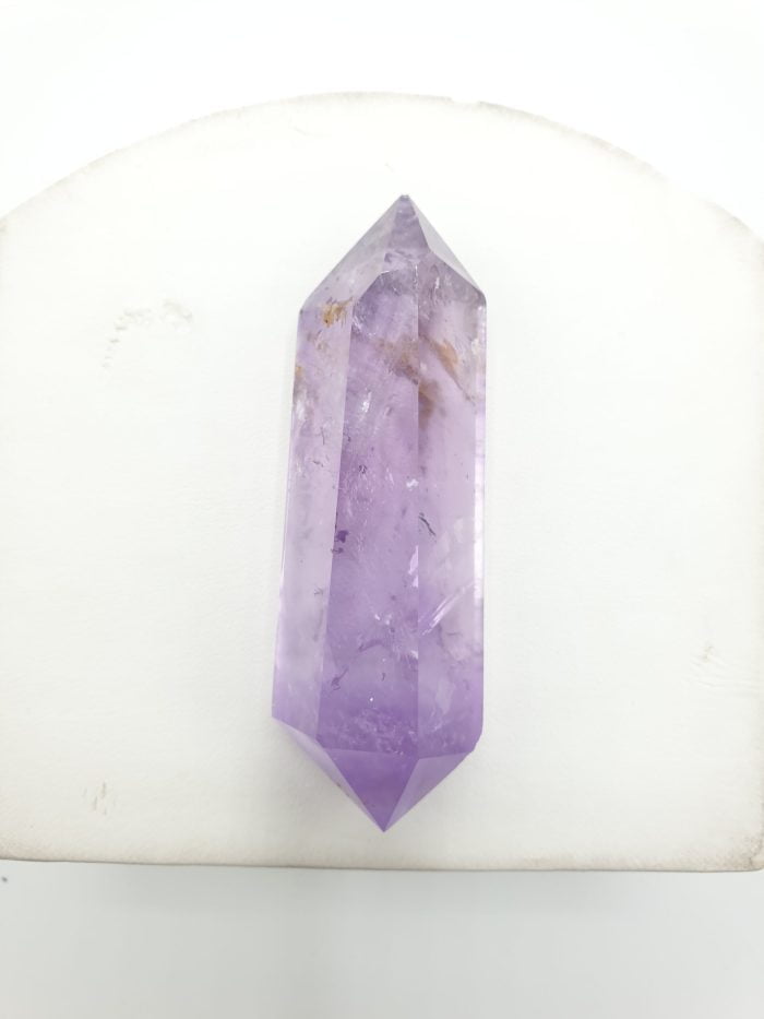 Purple amethyst biterminated tips on a white table.