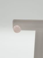 An earring with a ROSE QUARTZ EARRINGS 8 MM IN SILVER on top of a white object.