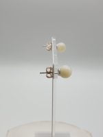 MOTHER-OF-PEARL EARRINGS MM 8 IN SILVER earrings on easel.