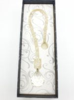 A necklace SUNCATCHER I CRISTALLI CAPTURES SUN ROCK CRYSTAL enclosed in a black box.