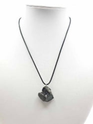 An ELITE SHUNGITE PENDANT necklace with a black stone on top.