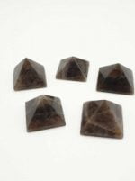 Four brown stones SMOKY QUARTZ PYRAMID 3 CM on a white background.