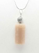 A SUNSTONE PENDANT on a silver chain.