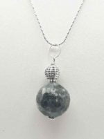 A LABRADORITE PENDANT featuring a labradorite stone.