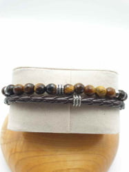 A MEN'S BRACELET WITH TIGER'S EYE, BROWN LEATHER CORD AND STEEL CLASP with brown leather cord and steel clasp.