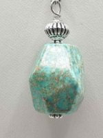 An imperial jasper pendant suspended from a silver chain.