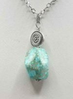 AN IMPERIAL JASPER PENDANT on a silver chain.
