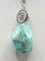 AN IMPERIAL JASPER PENDANT on a silver chain.