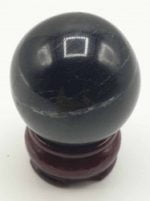 A BLACK TOURMALINE SPHERE.