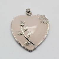 A heart-shaped pendant with rose quartz and plated brass bezels.