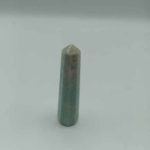 A green AMAZONITE OBELISK product on a white surface.