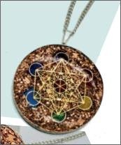 A METATRON'S CUBE ORGONITE PENDANT NECKLACE, representing the seven chakras.