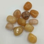 A bunch of stones RED AVENTURINE TUMBLED on a white background.