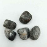Group of stones of TUMBLED TOURMALINATED QUARTZ on a white background.