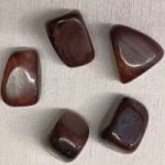 Group of stones BULL'S EYE tumbled on a white background.